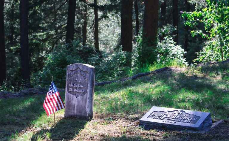 An American flag placed at a veteran's grave before Memorial Day