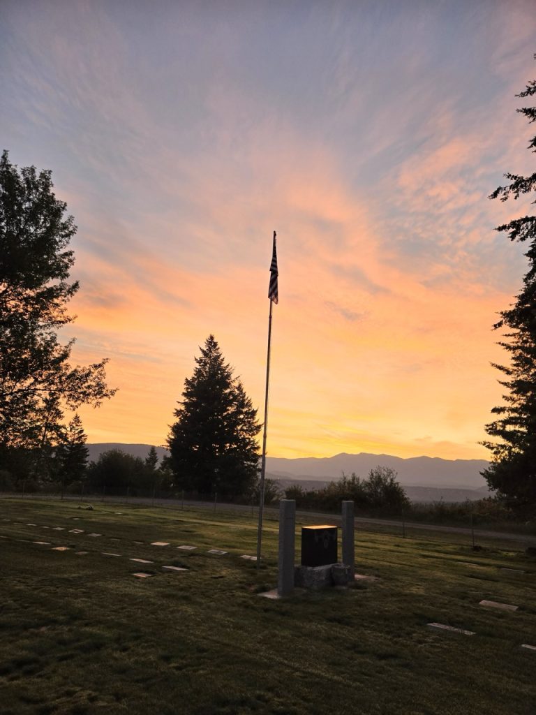 Flagpole and memorial at sunset