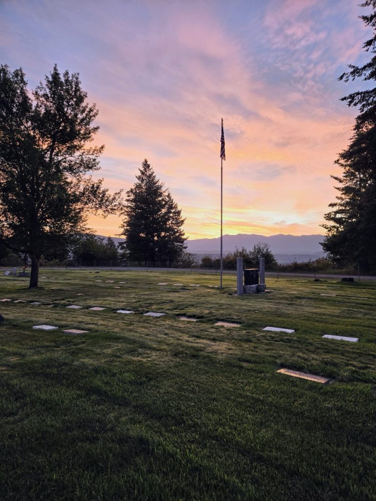 The flag at Grandview Cemetery against a sunset sky