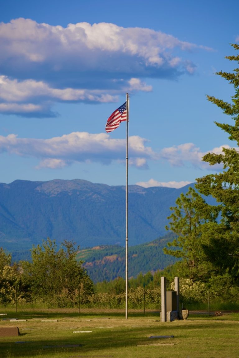 The flag above the valley and mountains
